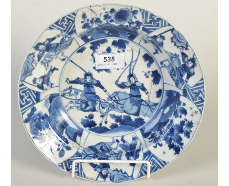 A Kangxi blue and white mark and period bowl the broad rim with alternating panels of warriors and pine trees, the central me