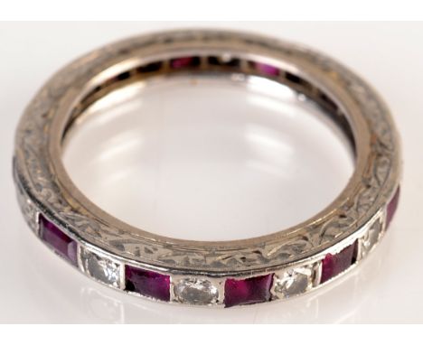 A ruby and diamond eternity ring. Condition Report: size L/K several stones with chips and scratches
