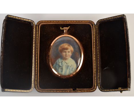 A miniature portrait of a boy in gilt pendant frame and with gilt leather easel case by Jarrold & Co, Sloane Street.