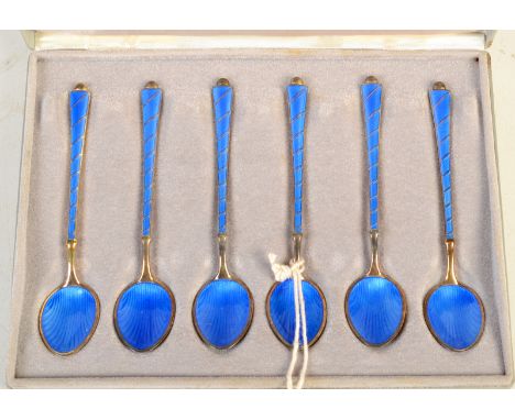 A set of six Danish silver gilt and blue enamel coffee spoons, cased. 
