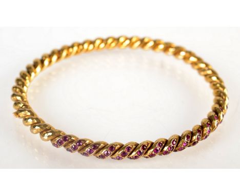 A French, high purity gold hinged bangle, set with rubies.