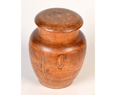 A Victorian turned wood baluster tea caddy with inner lid and cover. Height 13.5cm.