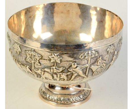 An Indian repousse decorated footed bowl with a continuous scene of tiger and elephant hunting and rickshaws, diameter 20.5cm