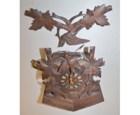 A Black Forest oak cuckoo clock.