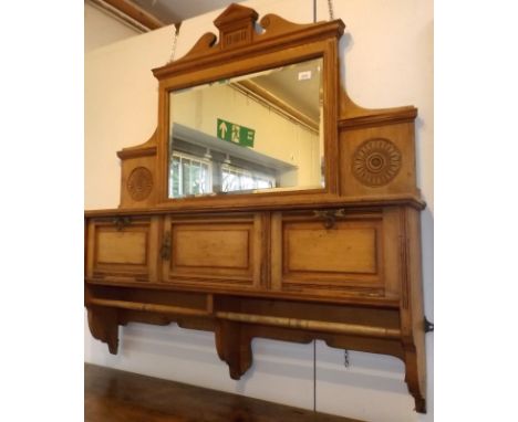 A high Victorian light oak cloakroom mirror with an open shelf, compartments and towel rails.