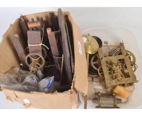 A clock movement with wooden frame, together with one other movement, pendulums etc.