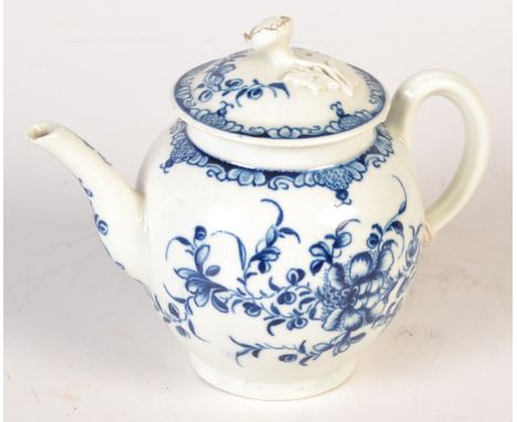 An 18th century Worcester blue and white teapot painted with flowers beneath a foliage band, the matching lid with a flower a