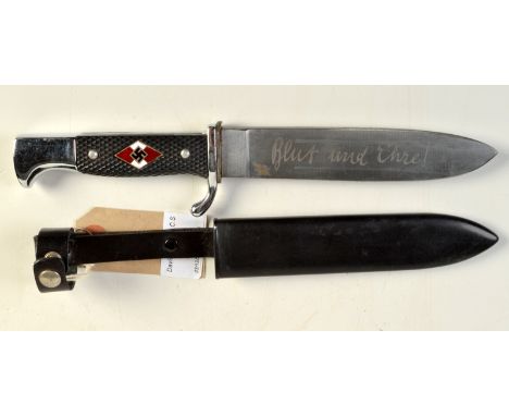 A Hitler Youth knife, the handle enamelled with swastikas, the blade engraved and with its original metal scabbard.
