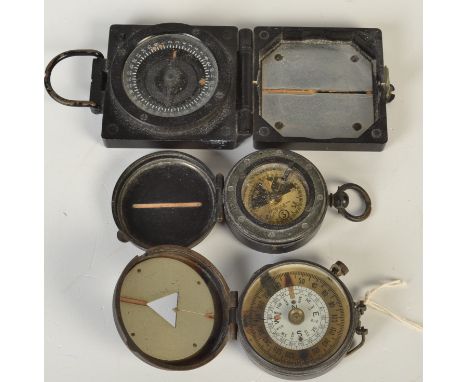 An S. Mordan brass field compass 1918, a similar compass by Barker & Son and a Mark I `Marching Compass`.
