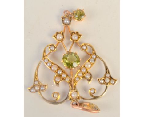 A gold Art Nouveau peridot and pearl pendant.