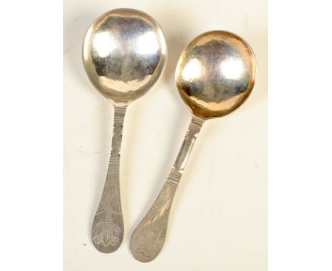 Two Scandinavian silver spoons, each with a flower engraved finial, one dated 1801, the other 1723.