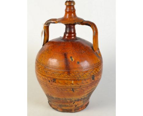 An antique mediterranean honey glazed large jar with incised decoration and twin handles, height 43.5cm. 