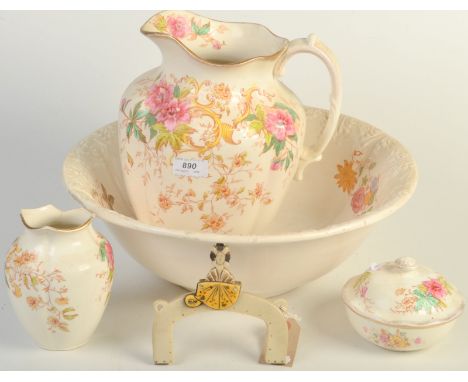 A Fieldings 'Rhodes' pattern toilet jug and basin, a matching toothbrush holder and soap dish and one other piece.