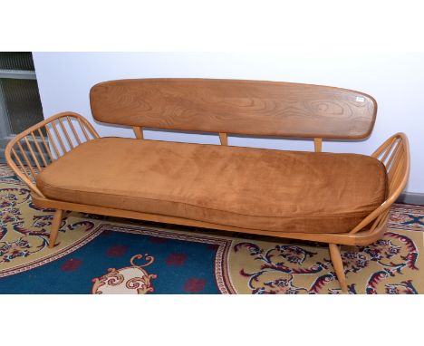 An Ercol daybed with detachable elm back rest and stick ends.