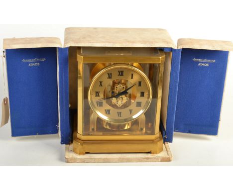 A Jaeger-leCoultre with black Roman numerals on gilt chapter ring, numbered 6539, original box.