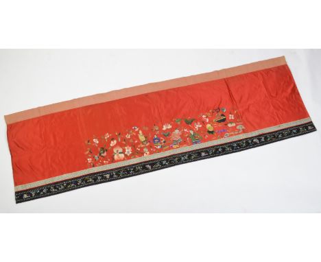 A 19th century Chinese Beijing embroidered wall panel decorated with the 'Immortal Twins' 'Hehe Erxian', each with symbolic s