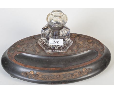 A Victorian gilt brass mounted ink stand with hexagonal glass inkwell.