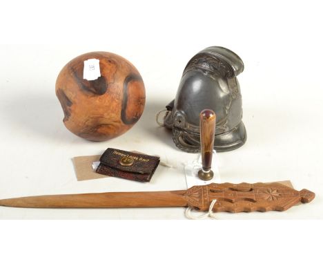 A fireman's helmet inkwell in white metal and a treen ball etc.