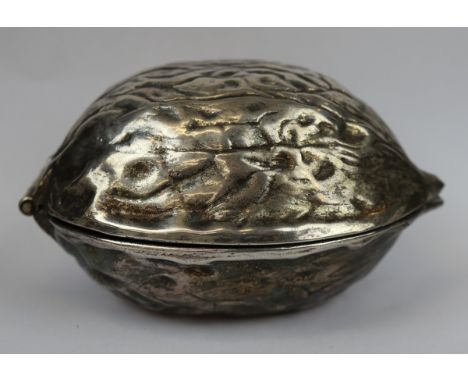 White metal nutcracker in the form of a large nut