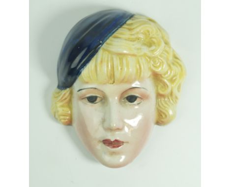 An Art Deco style Cope & Co ceramic wall mask Depicting a lady wearing a blue cap with blonde curly hair, impressed marks and