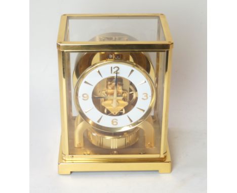 A Jaeger Lecoultre 'Atmos' clockOf typical form with brass frame, the circular dial with Arabic numerals, height 23cm   CONDI
