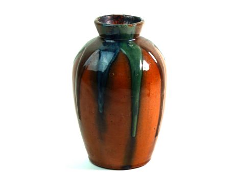 An English Arts & Crafts ceramic vase of cylindrical formIn the manner of Dr Christopher Dresser, having dripped glaze decora