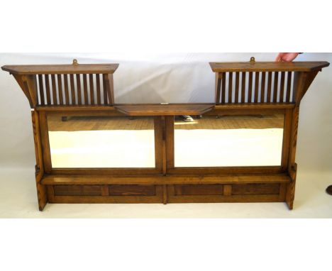 An Arts & Crafts medium oak over mantle mirrorProduced for Liberty & Co, having two mirror plates and single shelf, bears ori