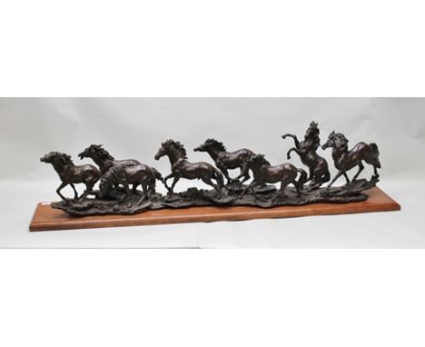 20TH CENTURY CAST PATINATED BRONZE GROUP OF EIGHT RUNNING WILD MUSTANGS, on ground work base, mounted onto an oak plinth base