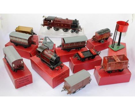 A HORNBY 0-GAUGE TIN-PLATE TRAIN SET, comprising LMS Clockwork 4-4-2 Engine no. 6954, an LMS 2270 Engine, Rolling Stock, some