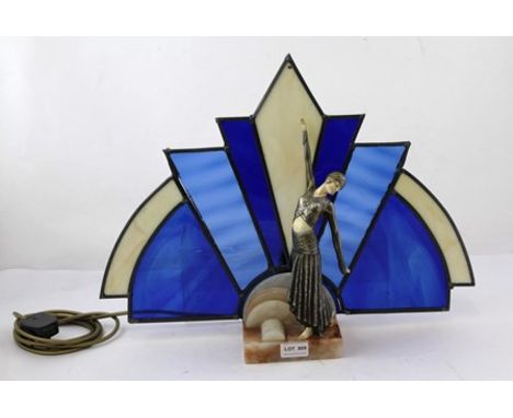 AN ART DECO STYLE FIGURAL LAMP, the dancing figure standing on an onyx base, the single rose fitting behind stained glass, 41