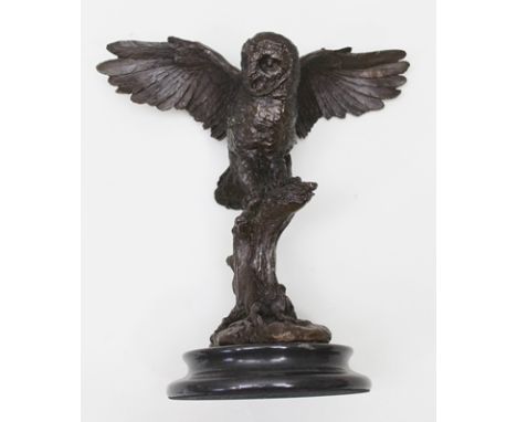 A 20TH CENTURY CAST PATINATED BRONZE OWL, wings outstretched, standing upon a tree stump, mounted upon a polished marble base