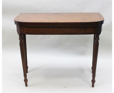 A REGENCY MAHOGANY FOLD OVER CARD TABLE raised on tapering fluted supports, 91cm wide 