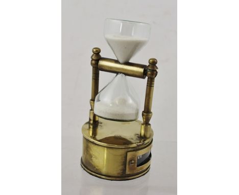 A SMALL BRASS COMBINATION SAND TIMER AND COMPASS, 12cm high 