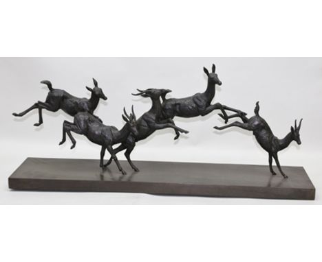 A 20TH CENTURY CAST PATINATED BRONZE GROUP OF FIVE RUNNING AND LEAPING ANTELOPE, on bronze plinth base, 88cm x 20cm 