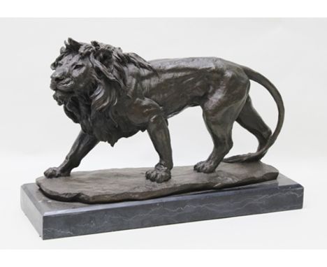 A 20TH CENTURY CAST PATINATED BRONZE IN THE CLASSICAL TRADITION OF A FULL STANDING, PROWLING MALE LION, having ground work ba