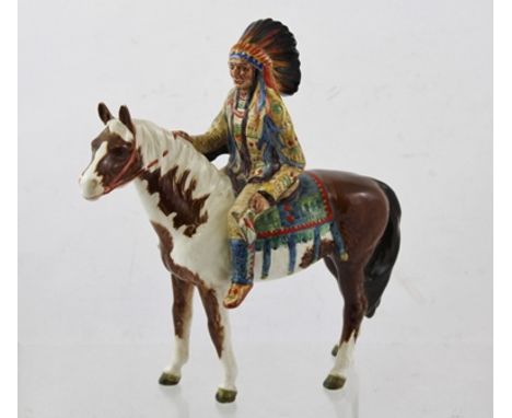 A BESWICK CERAMIC FIGURE OF A NORTH AMERICAN INDIAN mounted upon a skewbald horse, No.1391, 21cm high 