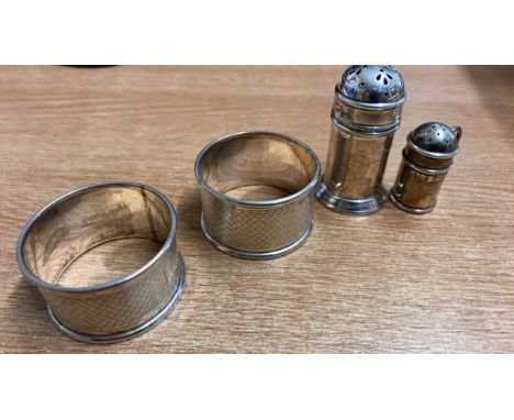  Sale Item:    2 SILVER NAPKIN RINGS &amp; 2 SILVER PEPPER POTS  Vat Status:   No Vat   Buyers Premium:  This lot is subject 