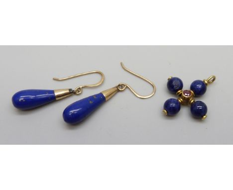 A pair of lapis lazuli earrings on yellow metal hooks and a yellow metal lapis and ruby pendant 