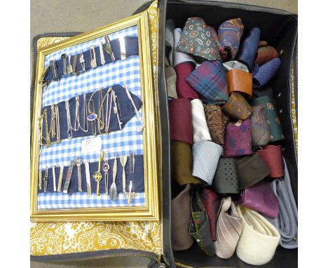 A collection of ties and a collection of tie bars 