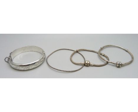 A hallmarked silver bangle, 18g, two Pandora bracelets and a rope twist bangle