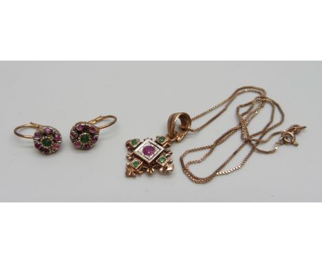 A silver gilt ruby and emerald set pendant on a chain and a pair of matching earrings 