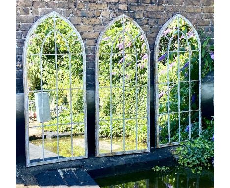 ARCHITECTURAL GARDEN MIRRORS, a set of three, aged metal frames, 159x67. (3) 