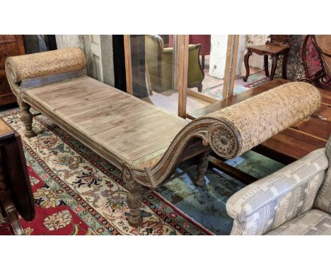 VERANDAH BENCH/DAYBED, 222cm L x 82cm H to one end x 63cm D Regency style Anglo-Indian faded teak with cane scroll ends on re