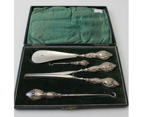 A cased silver handled shoe horn, button hooks, and glove stretchers, Chester 1909