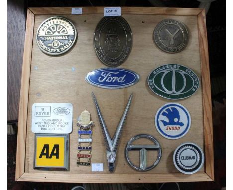 A presentation board mounted with metal car manufacturer badges, includes a Bugatti Owners Club membership badge with attache