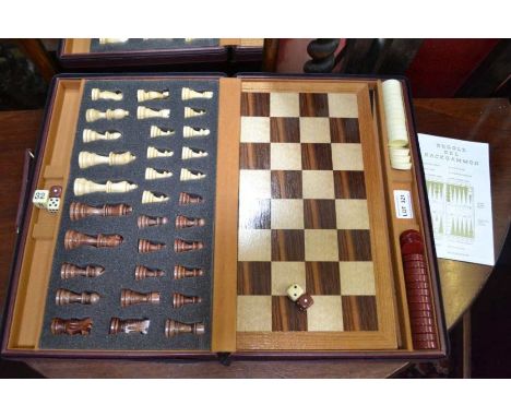 A cased travelling chess and backgammon set in leather effect carrycase