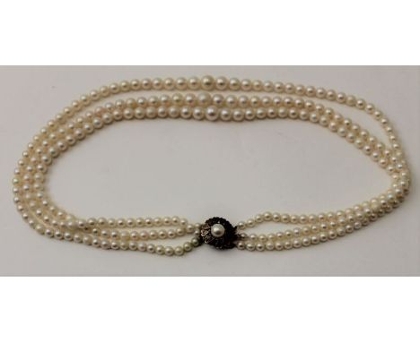 A triple strand cultured pearl necklace with 9ct gold clasp