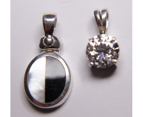 Two sterling silver pendants, one CZ and one onyx and mother of pearl