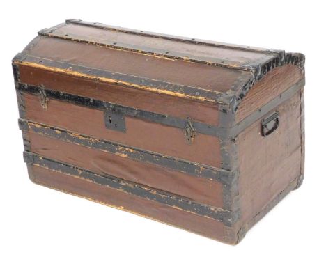 A Victorian brown canvas and pine bound trunk, of domed form, with metal carrying handles, 52cm high, 84.5cm wide, 46cm deep.