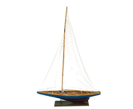 Nauticalia. A scale wooden model of a yacht, rigged with sails, on a wooden stand, 149cm high, 100cm wide.